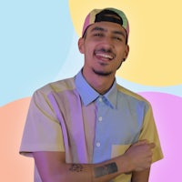 a young man wearing a colorful shirt and hat